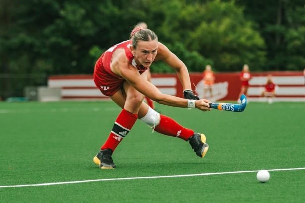 Junior back Emma Thompson pushes the ball against Ball State University